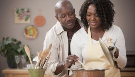 African American couple cooking together