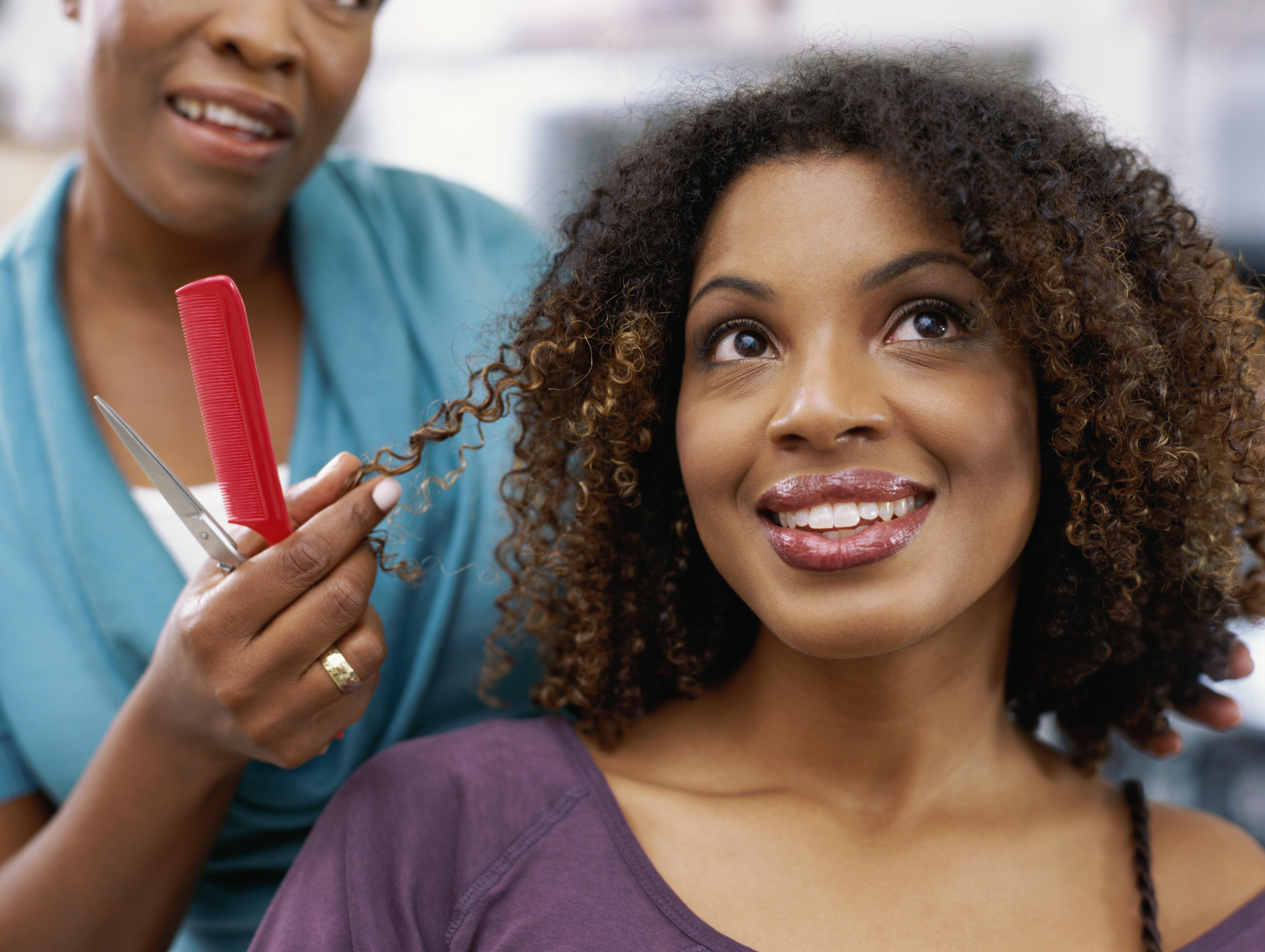 Close-up of a young woman having her hair done