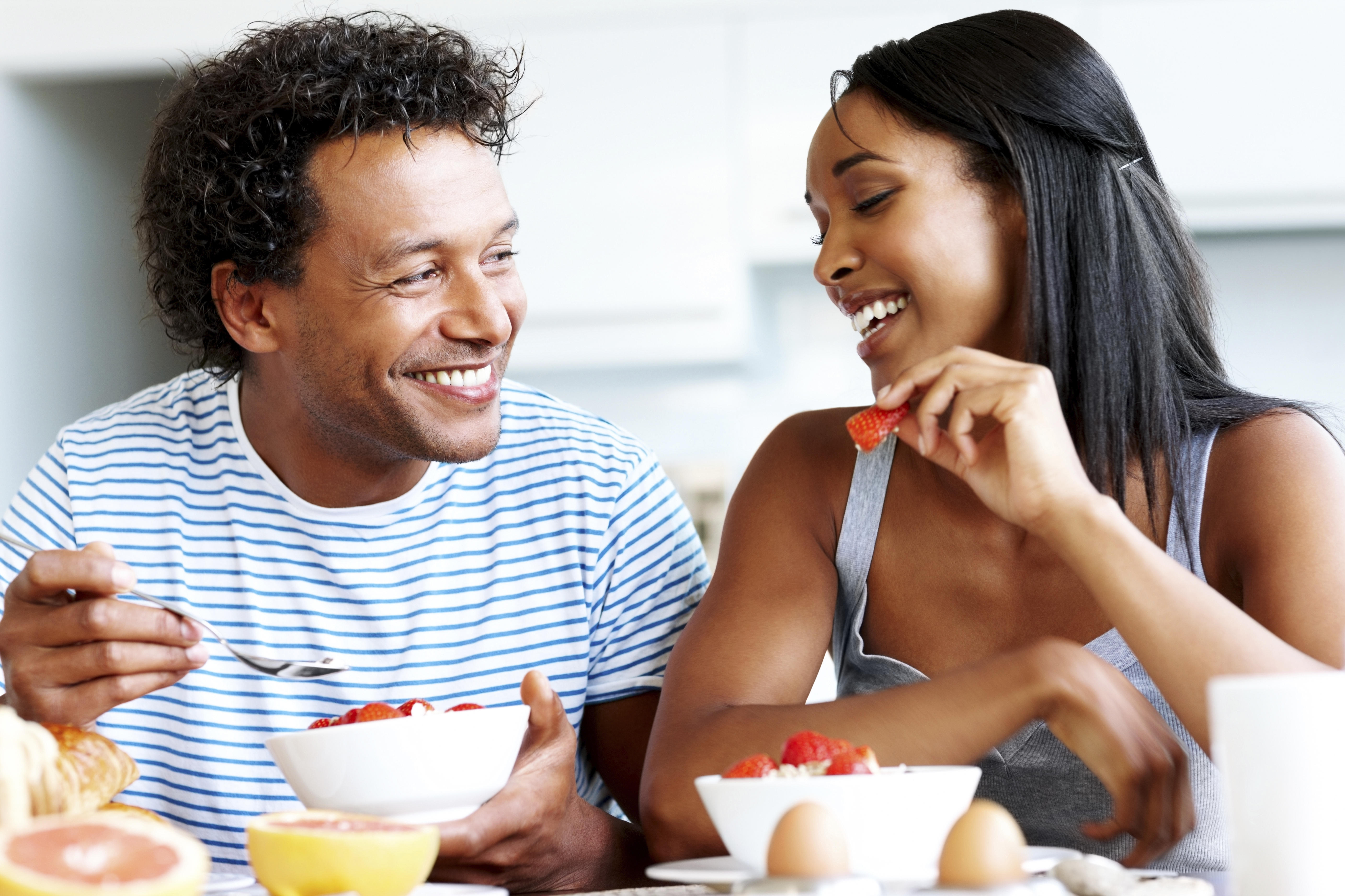 Happy couple having casual chat at breakfast table