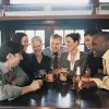 Businessmen and Businesswomen Work Colleagues Enjoying a Drink in a Bar