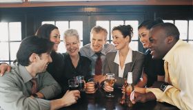 Businessmen and Businesswomen Work Colleagues Enjoying a Drink in a Bar
