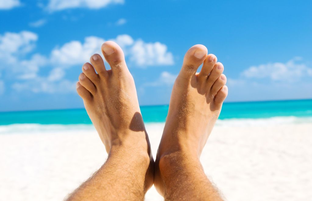 picture of male legs over tropical beach background