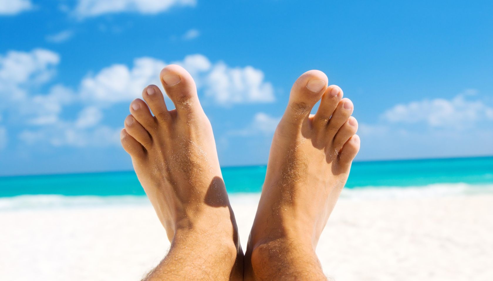 picture of male legs over tropical beach background
