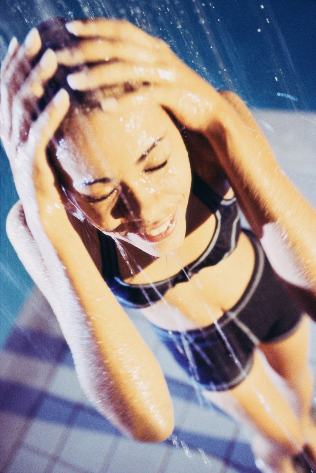 High angle view of a young woman standing under a shower