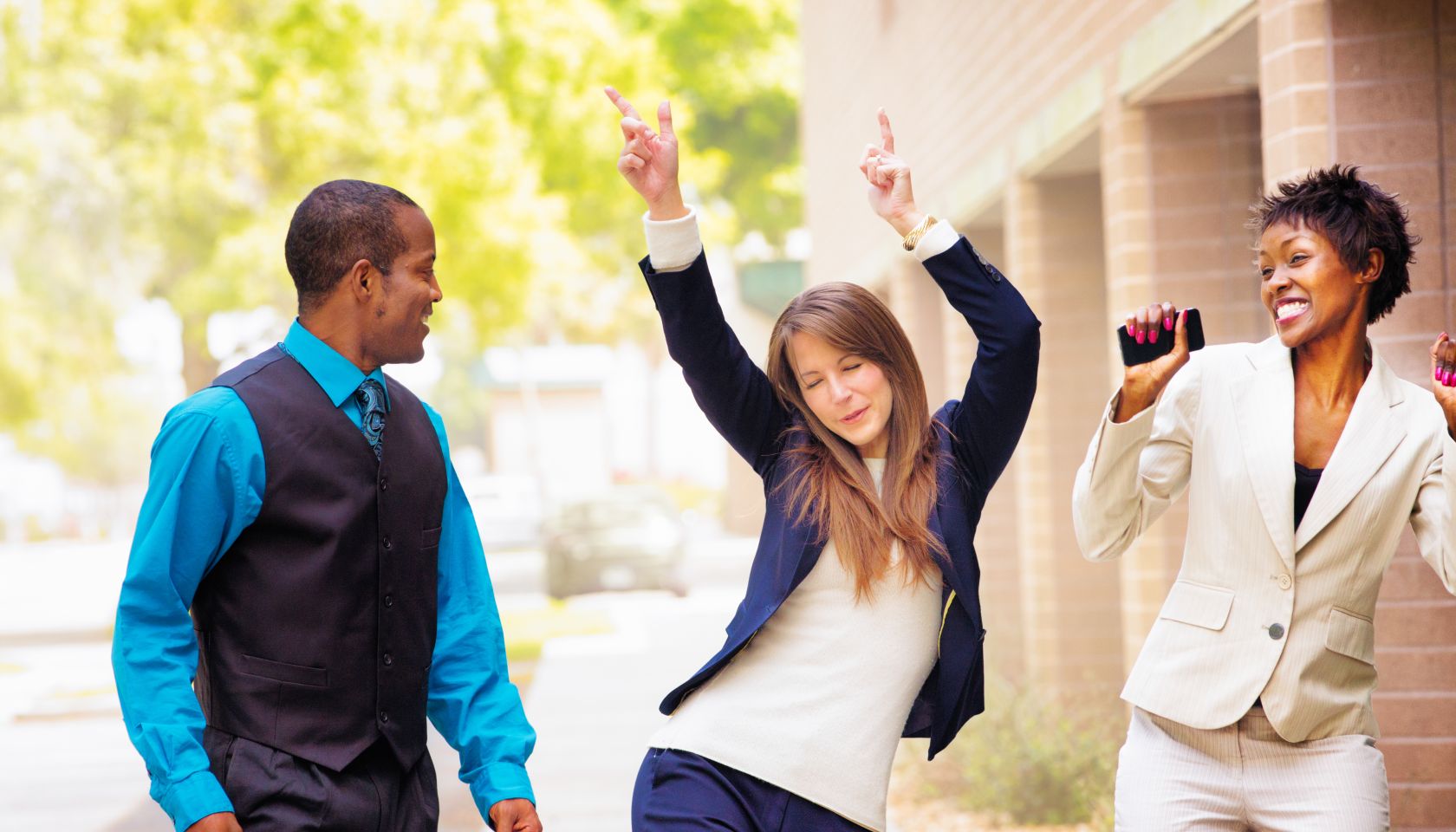 Office worker team does victory dance after receiving good news