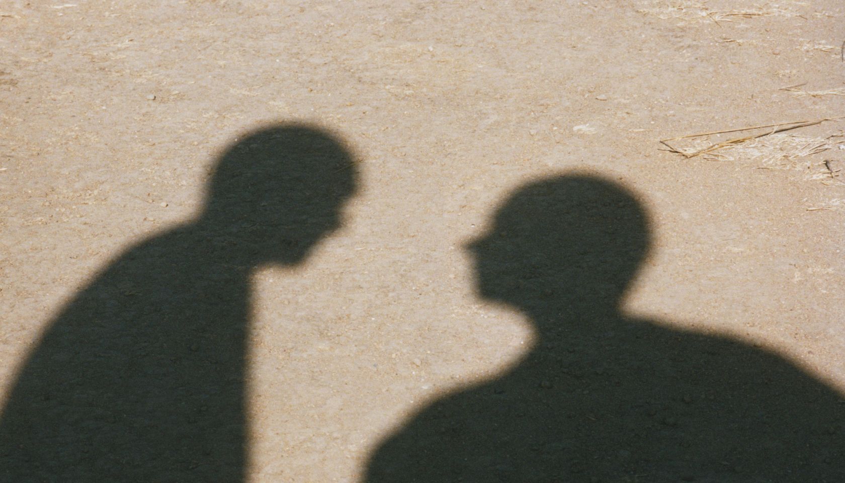 Shadows of Two Men in Desert