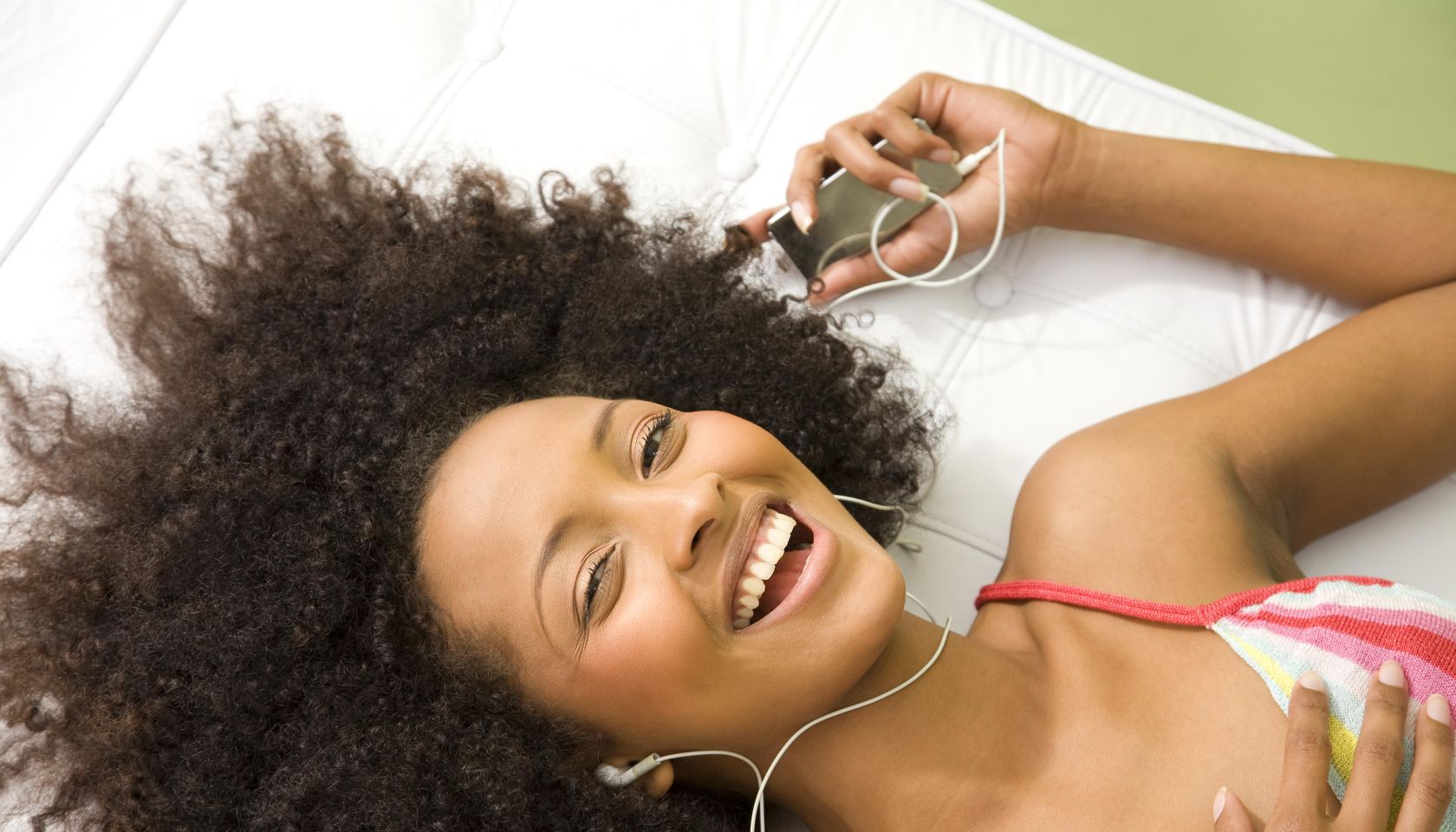 Laughing woman listening to mp3 player