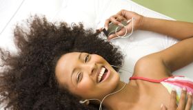 Laughing woman listening to mp3 player