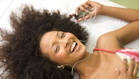 Laughing woman listening to mp3 player