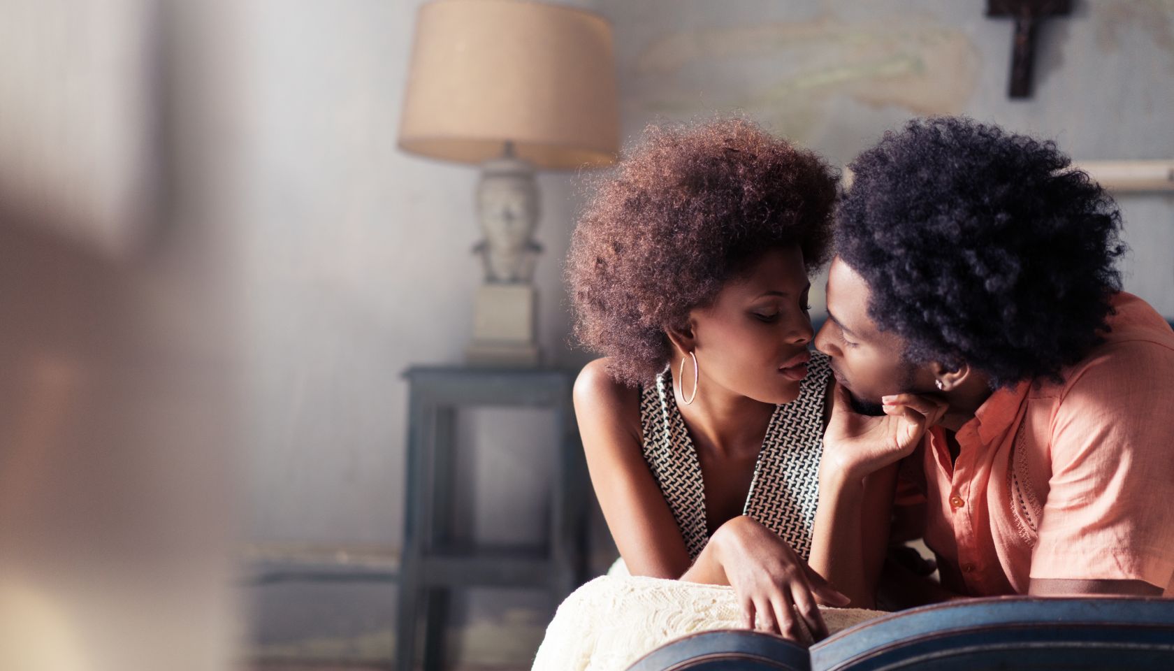 Passionate couple relaxing on bed at home