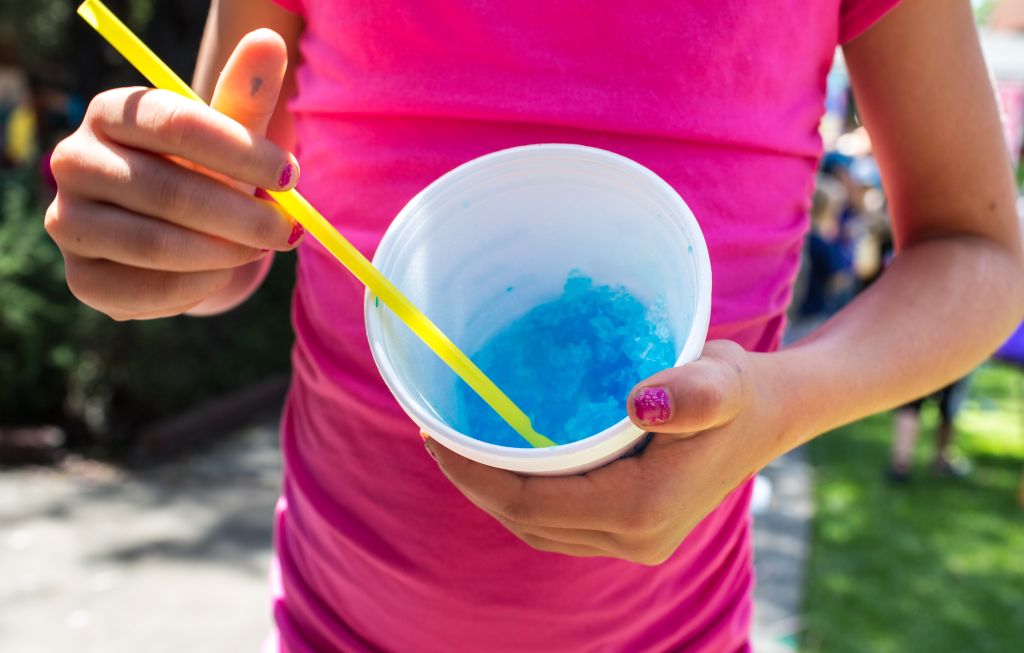 Female child holding sugary frozen dessert