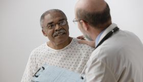 African man talking to doctor