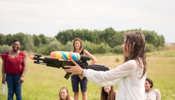 Girl shooting with a super soaker