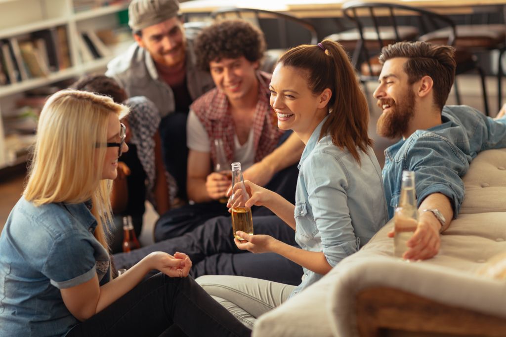 Photo of laughing friends enjoying beer and hanging out