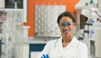 Black scientist smiling in laboratory