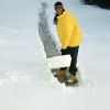 Teenage boy (16-18) shoveling path through snow, elevated view