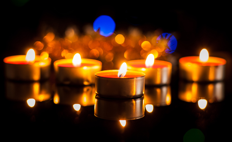 Small candles on a dark background burn evenly and quietly